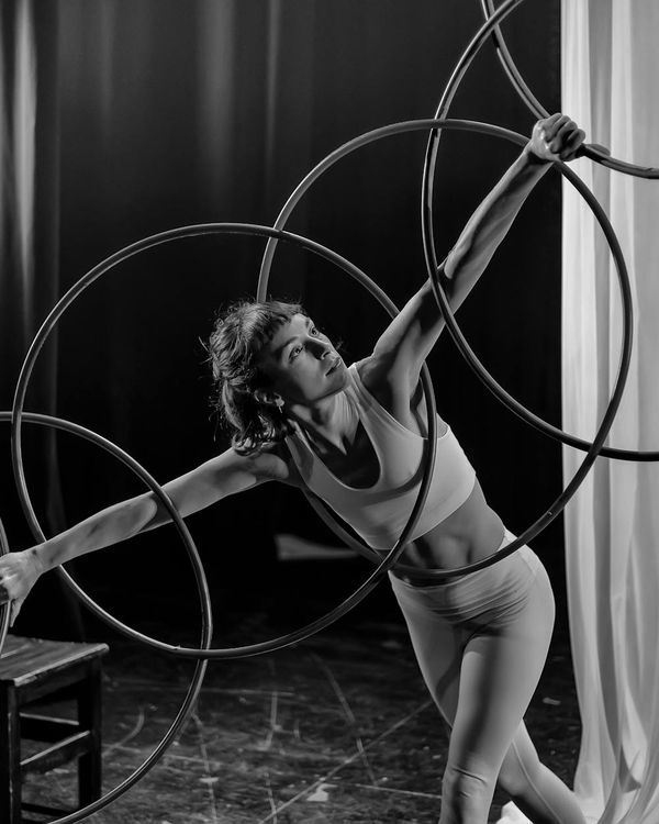 Woman performing a slow, mindful cardio movement in a minimalist studio.
